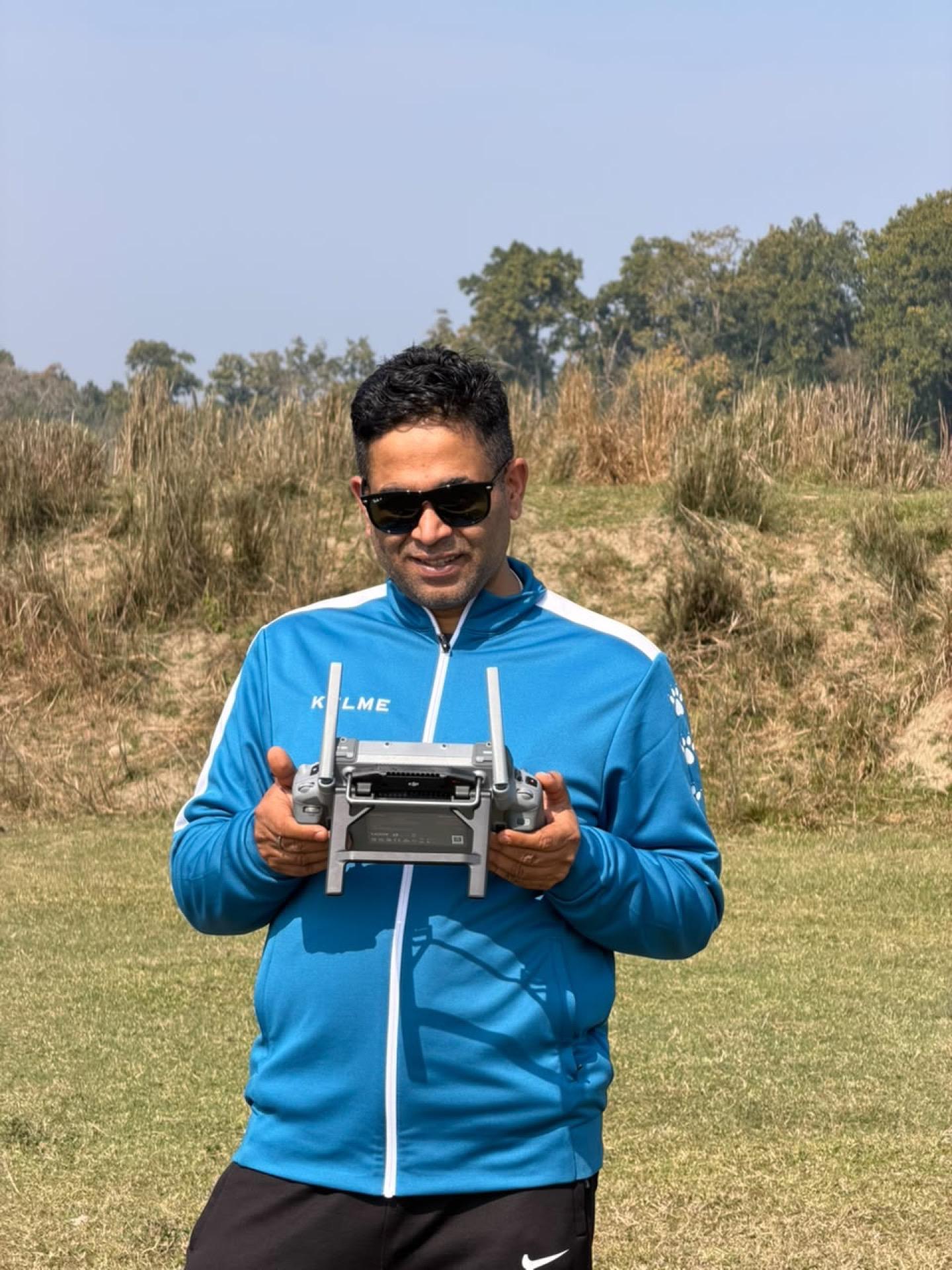 e2services pilot with a drone controller on a grass airstrip