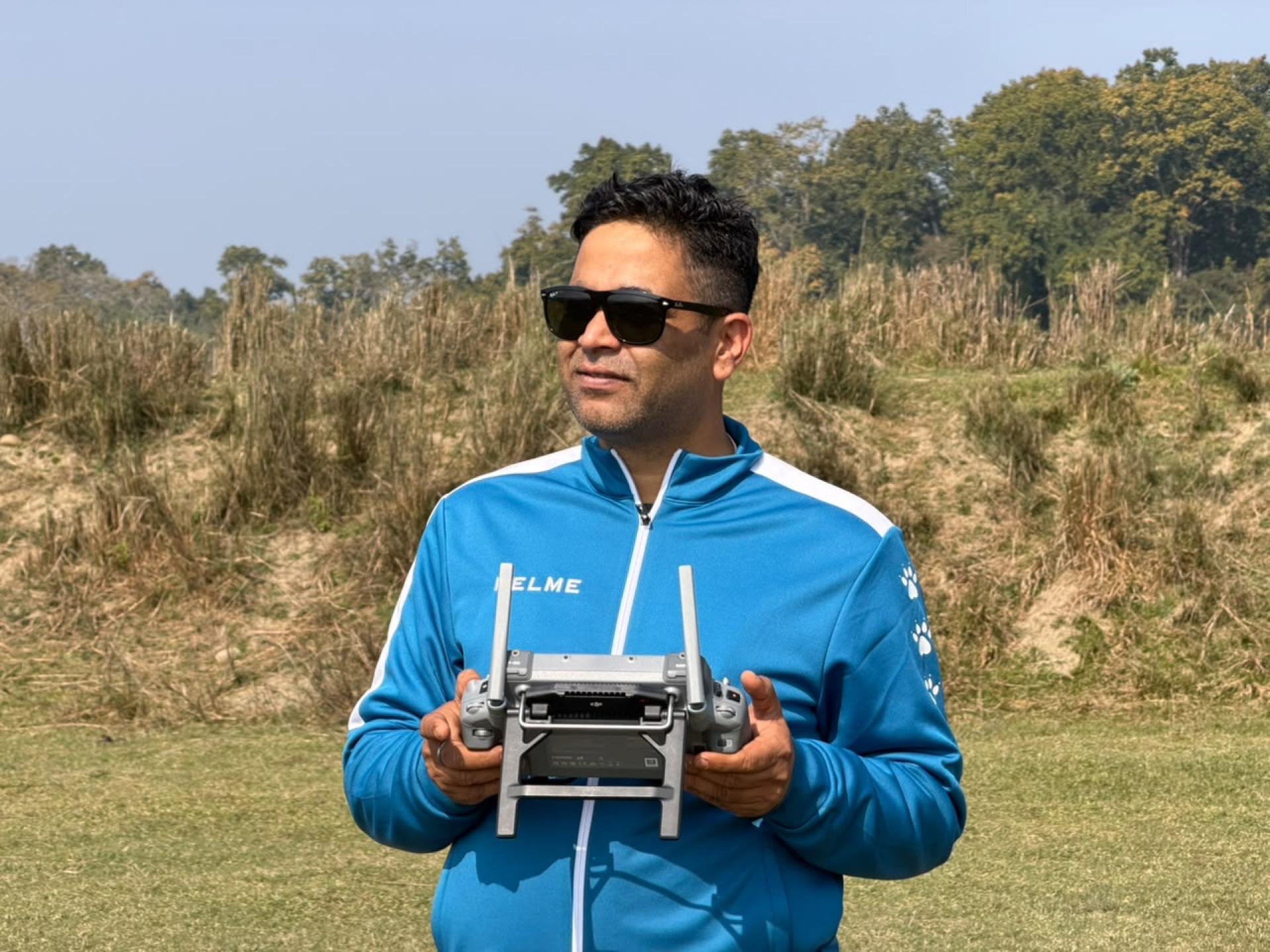 e2services pilot with a drone controller on a forest-edge survey site