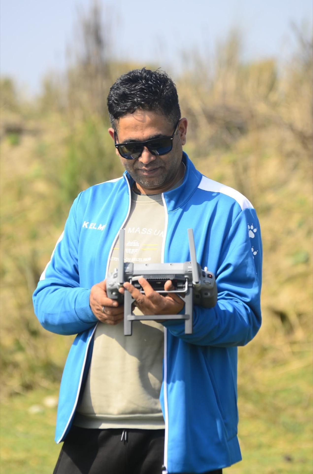 Pilot reviewing drone controller readings mid-flight