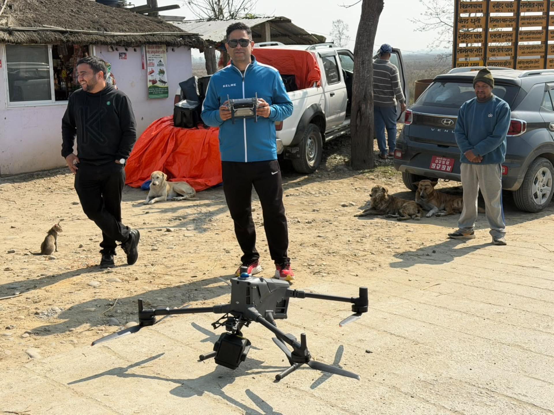Enterprise survey drone on the ground with the e2services field crew and project vehicles