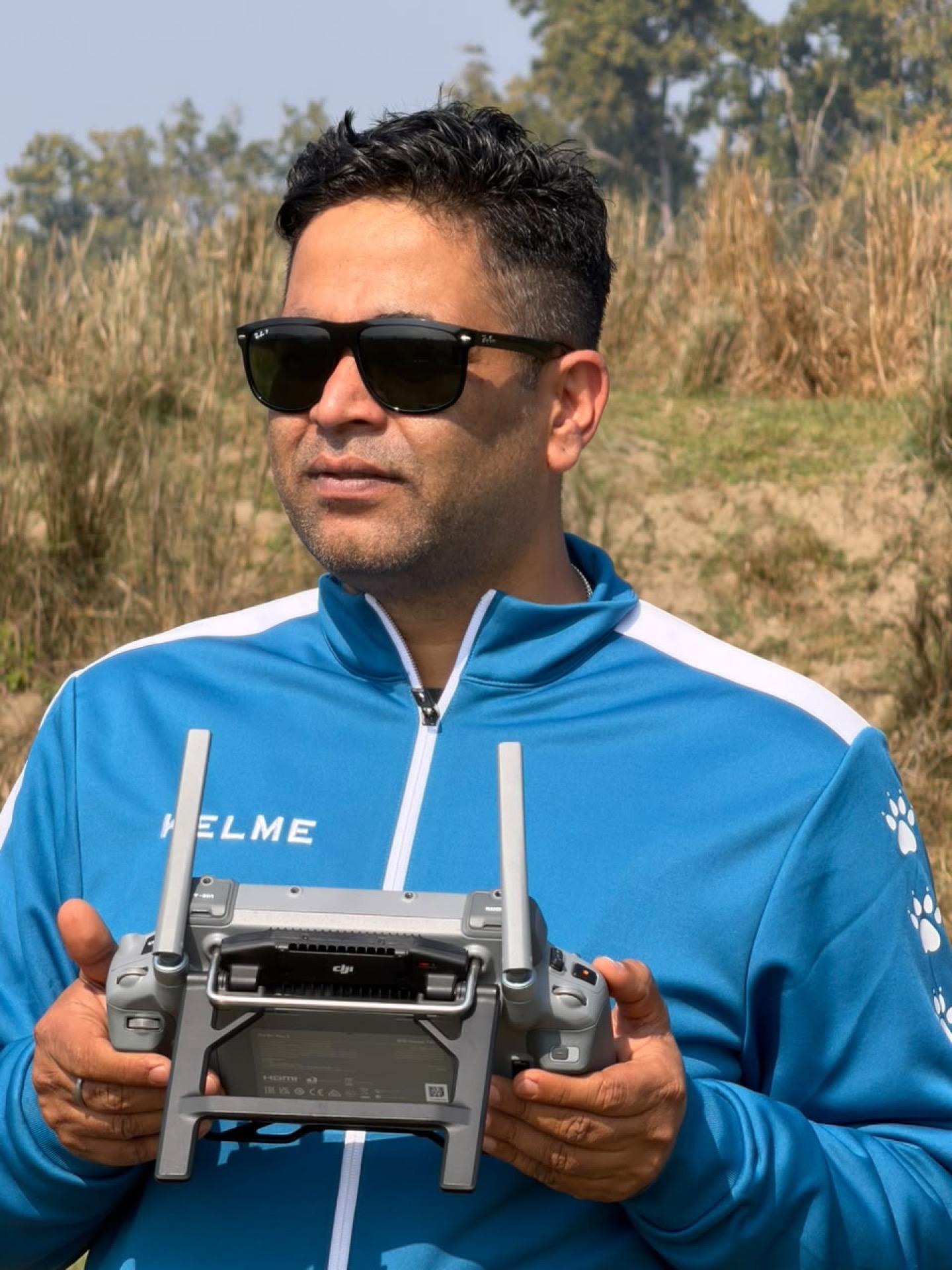 Drone pilot holding a controller at a survey location