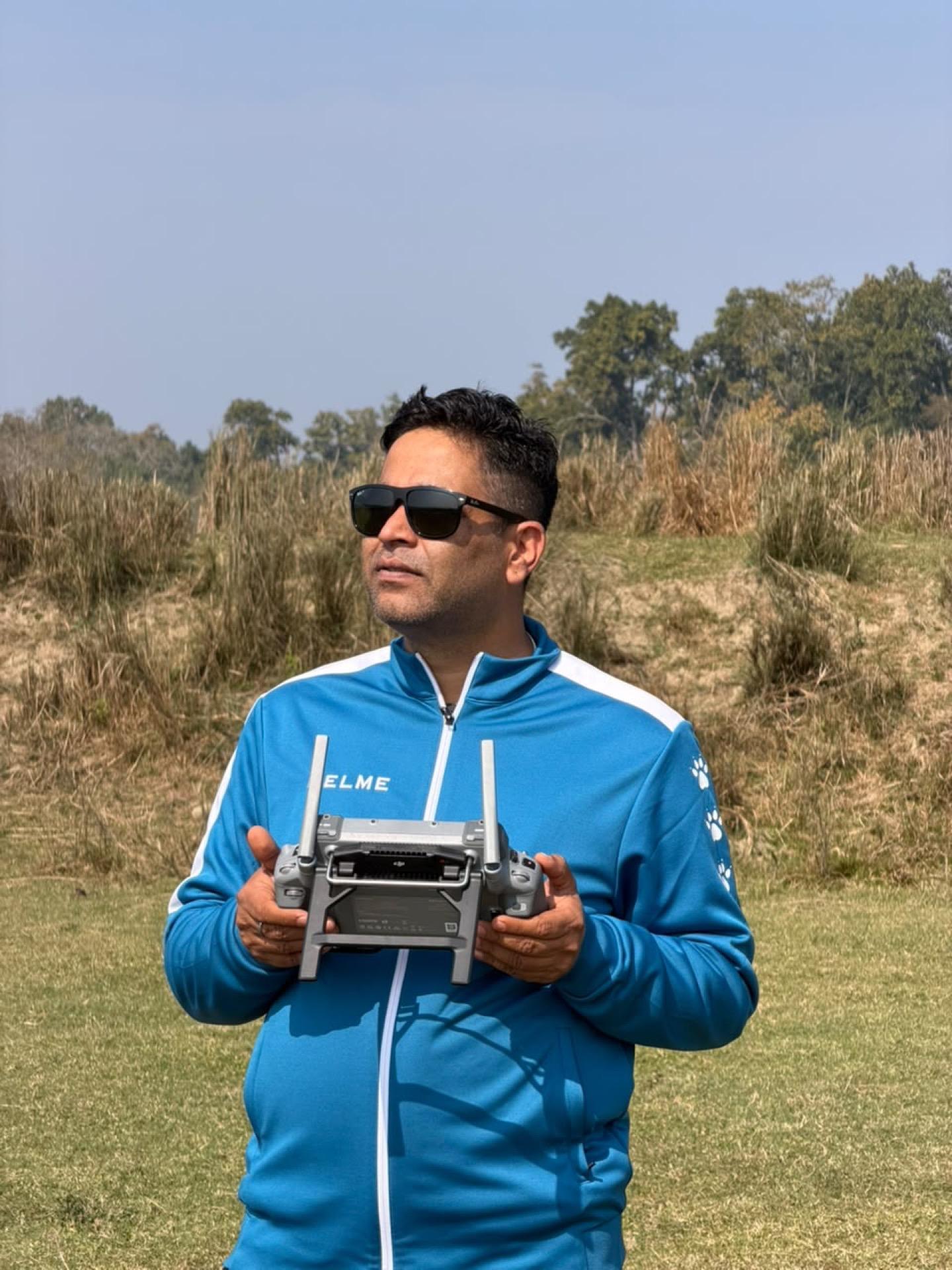Drone pilot preparing a mapping flight over open grassland