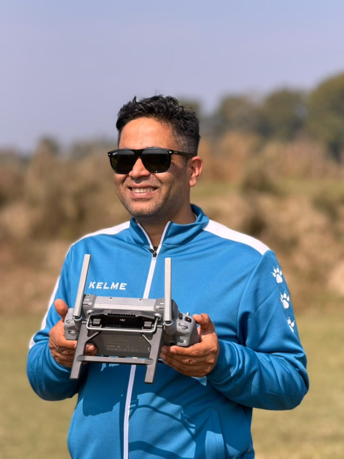 Survey team member operating drone equipment in the field